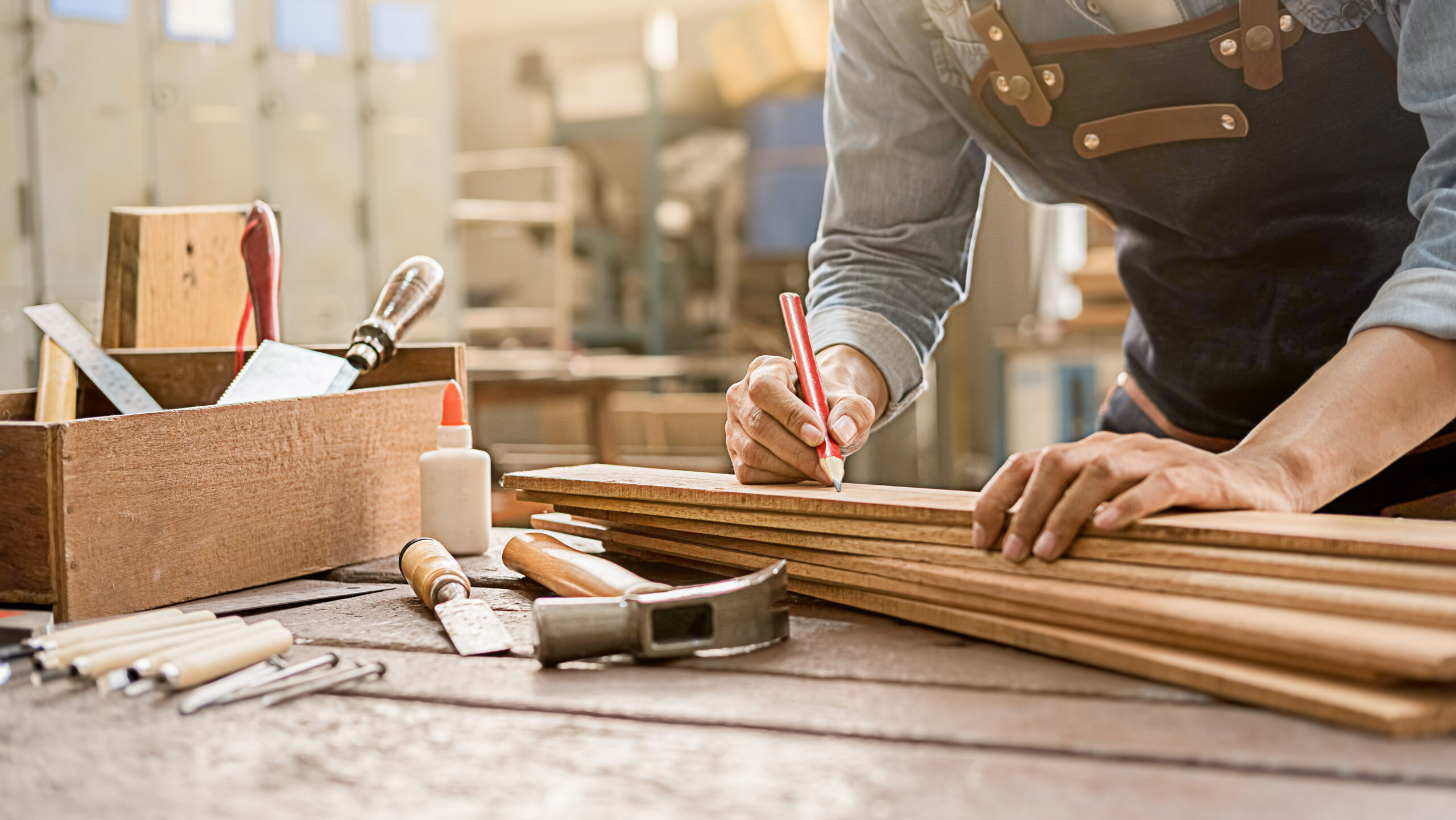 Carpenter,Working,With,Equipment,On,Wooden,Table,In,Carpentry,Shop.